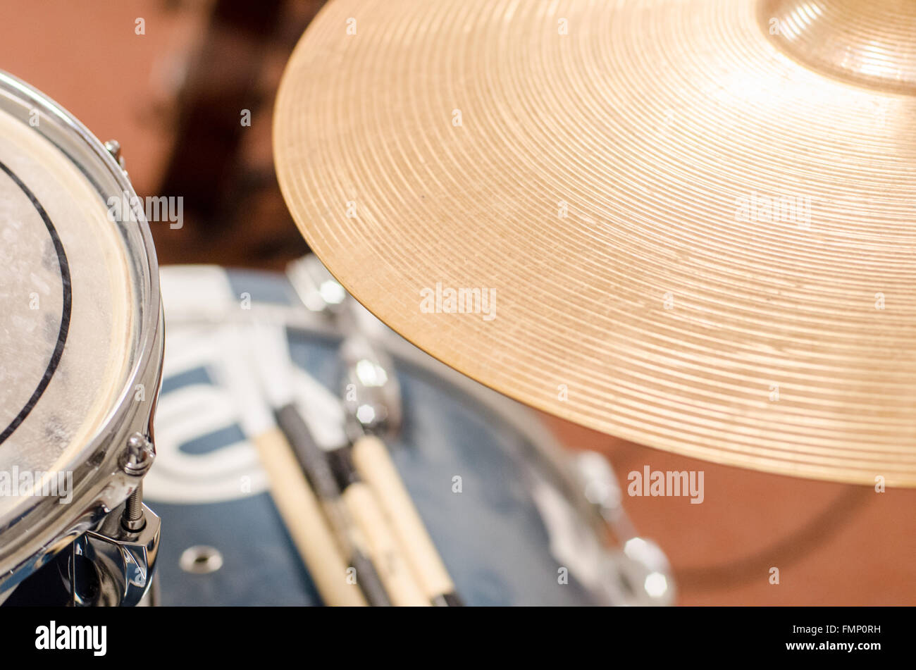 detail of drum set and sticks in rehearsing room Stock Photo