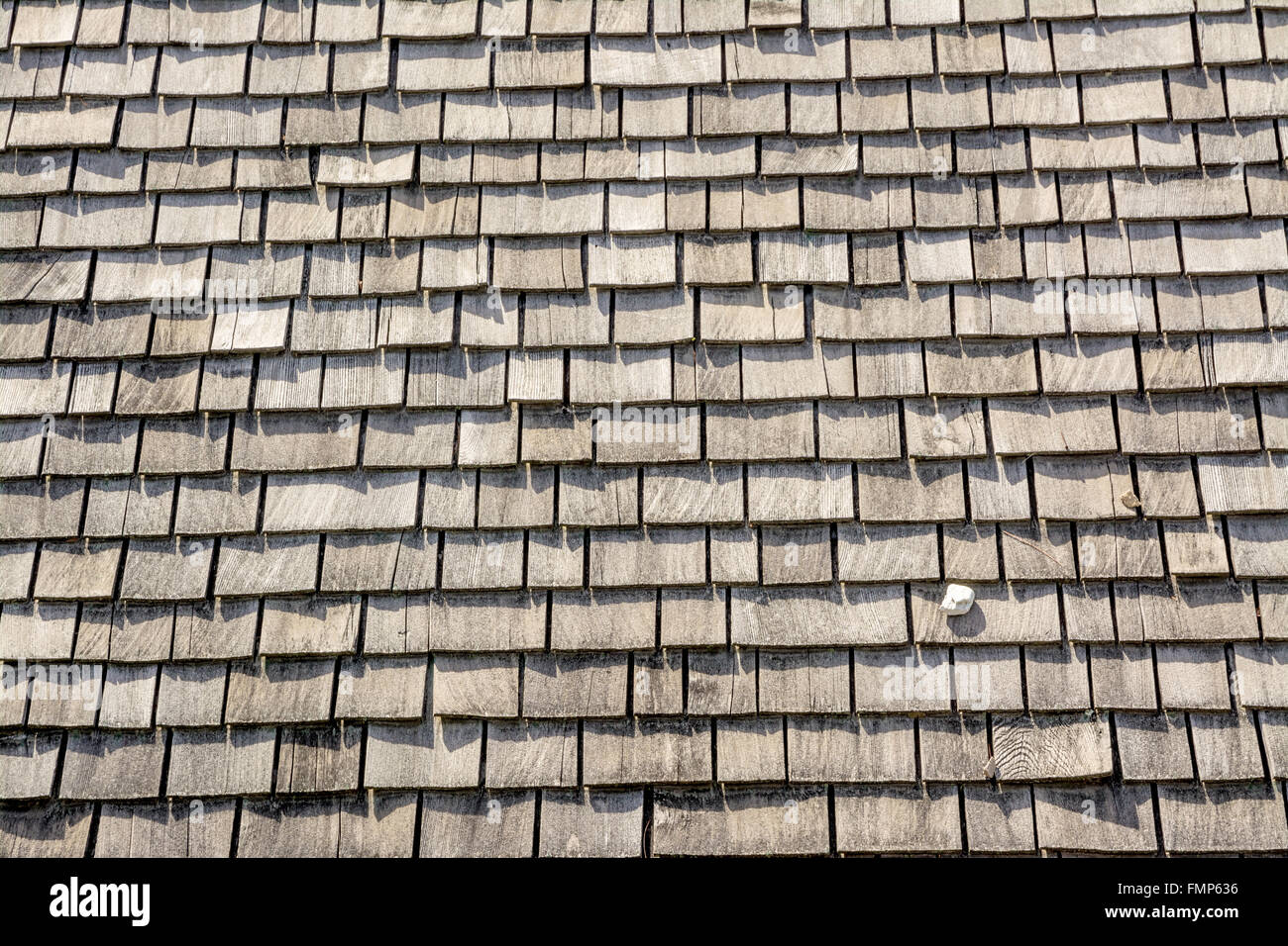 Wood roof shingles with a stone Stock Photo