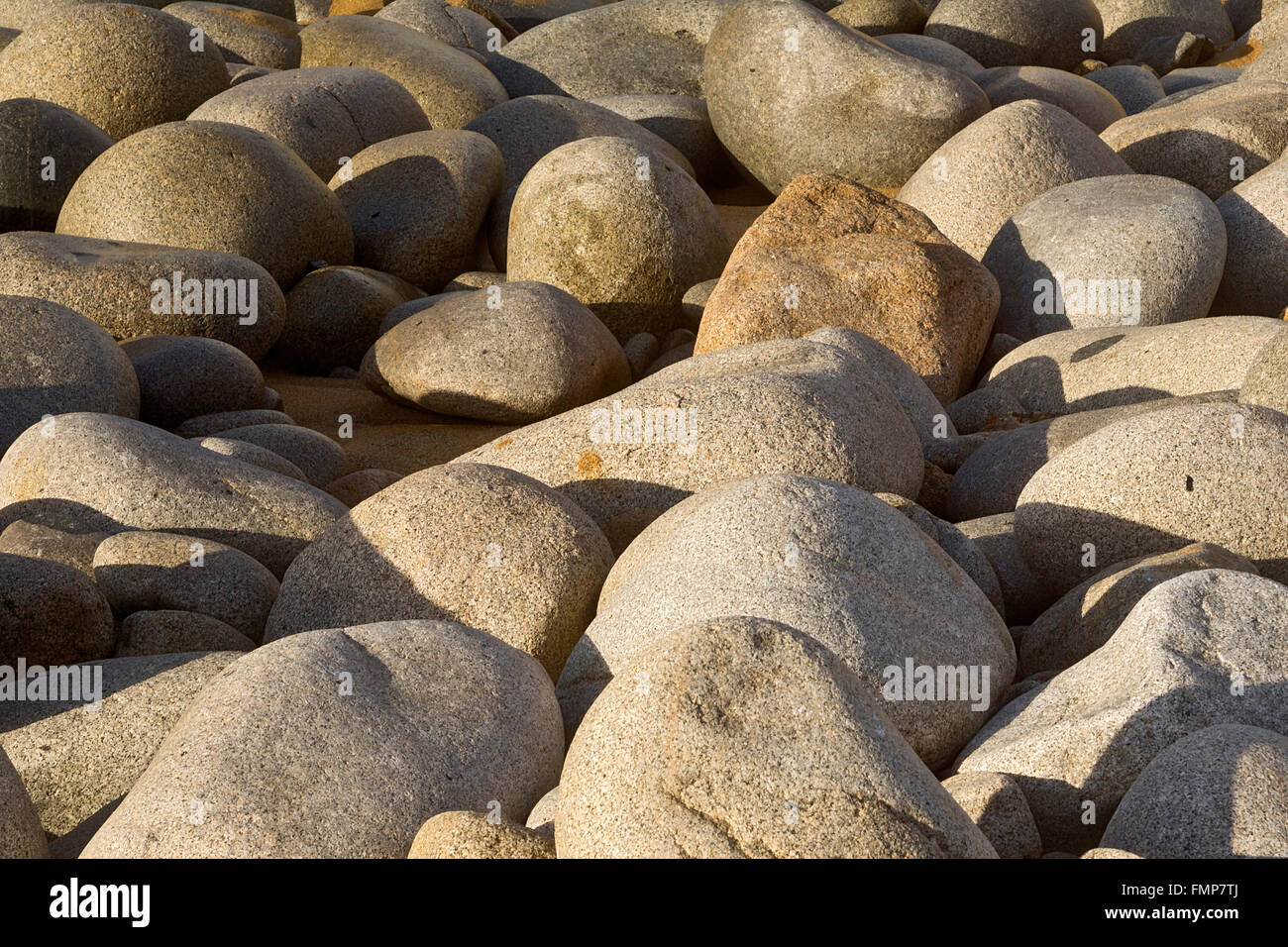 Round stones on the beach, coast at Capo Pecora, Buggerru, Sardinia, Italy Stock Photo