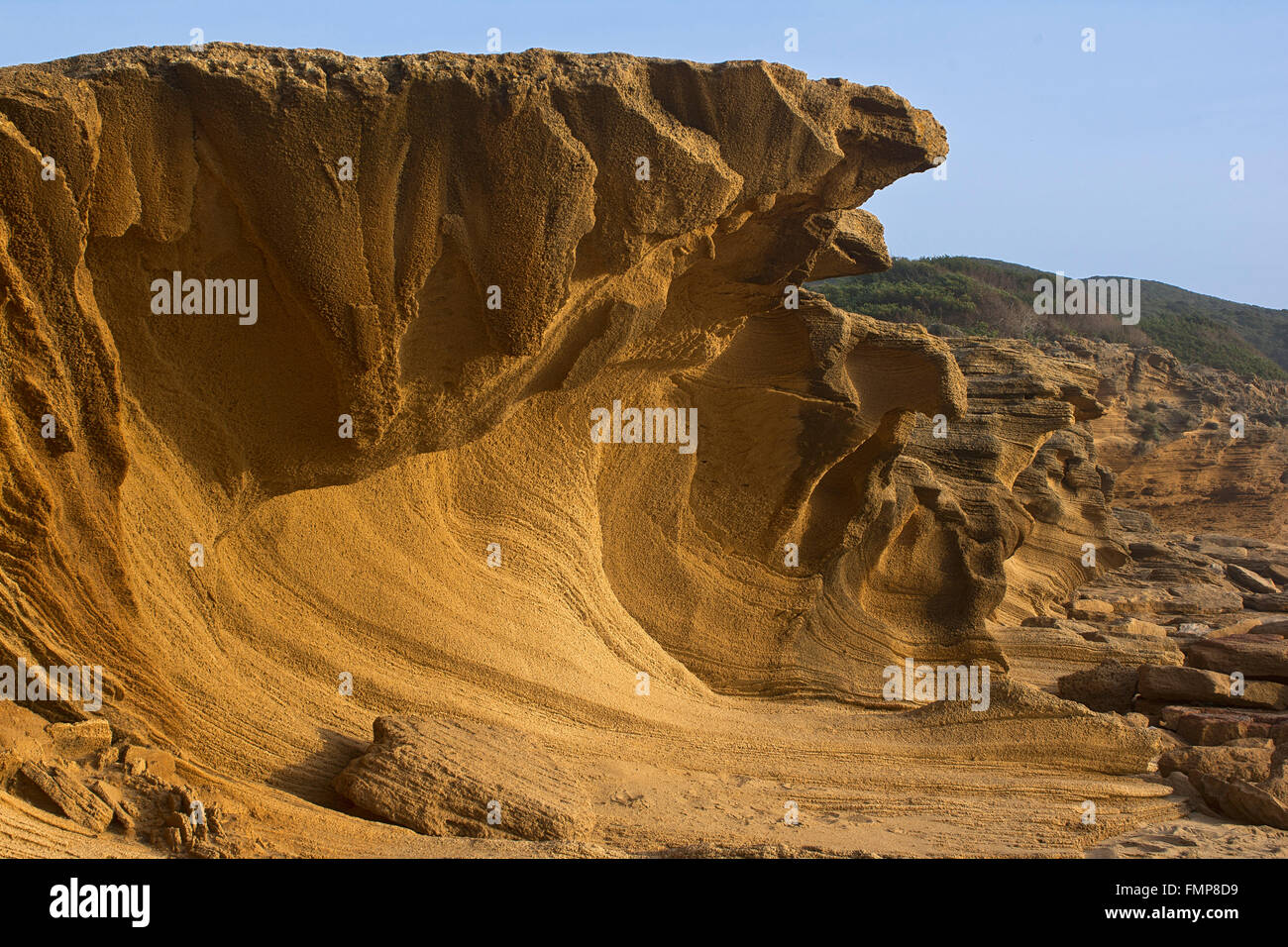 Washed out rock face, rock formation on the beach of Portu Maga, Costa Verde, Sardinia, Italy Stock Photo