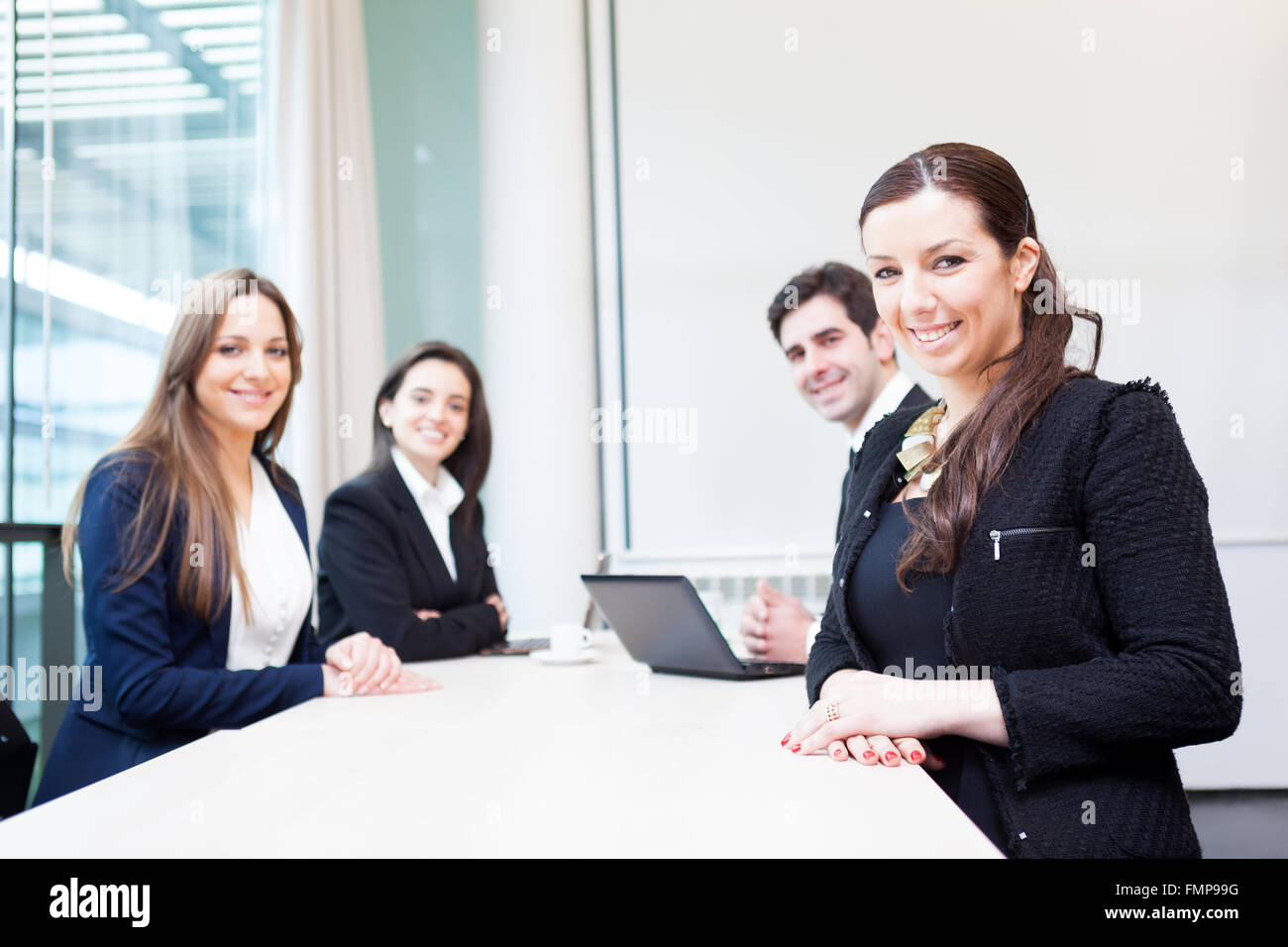 Group of business people smiling at the office Stock Photo - Alamy