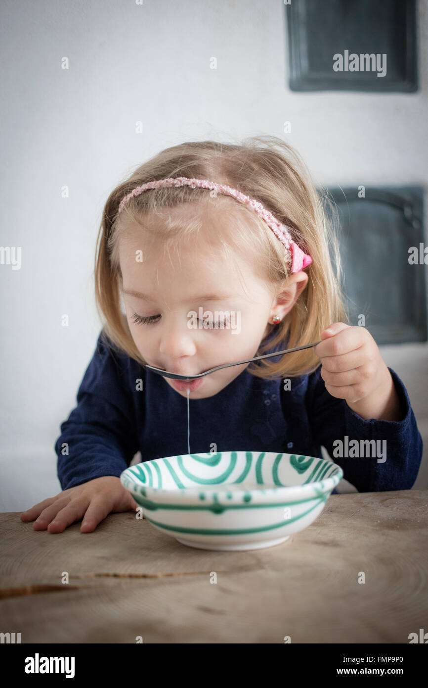 Little girl eating cereal from a bowl, Upper Bavaria, Germany Stock