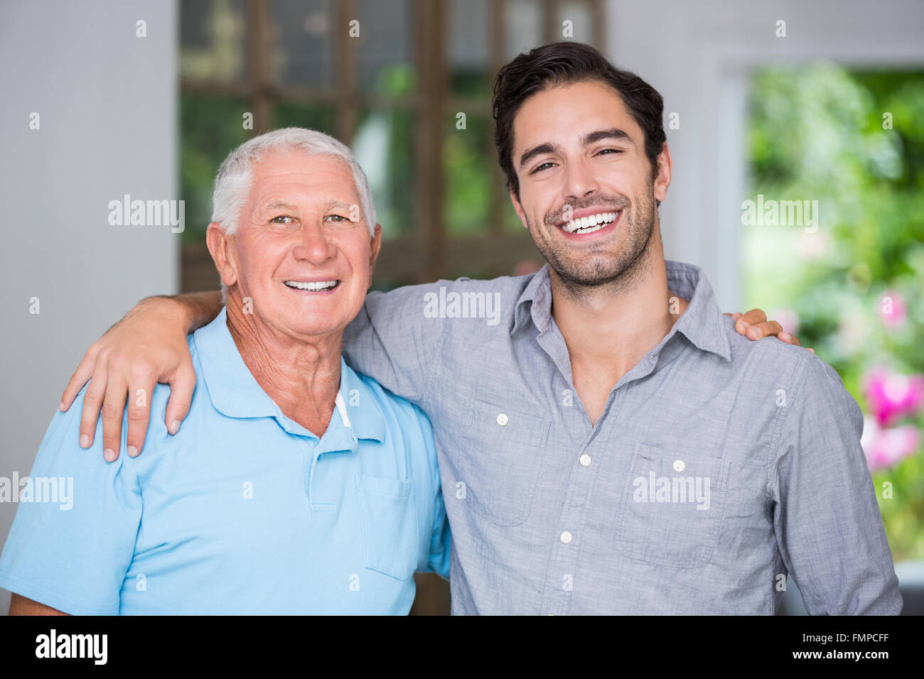 Smiling Father Portrait of smiling father and son with arm around Stock Photo - Alamy