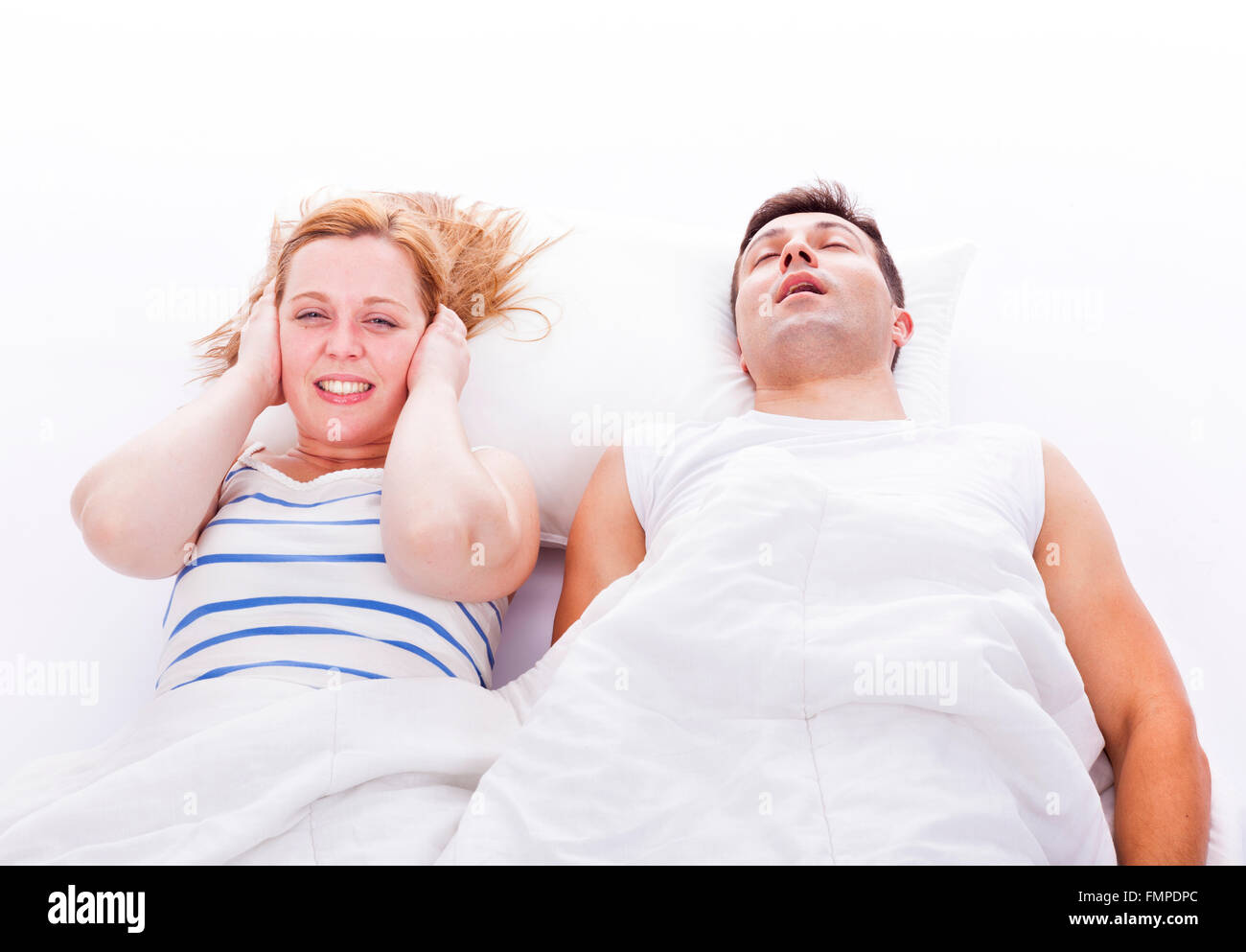 Snoring man, woman can not sleep, covering ears with pillow for snore