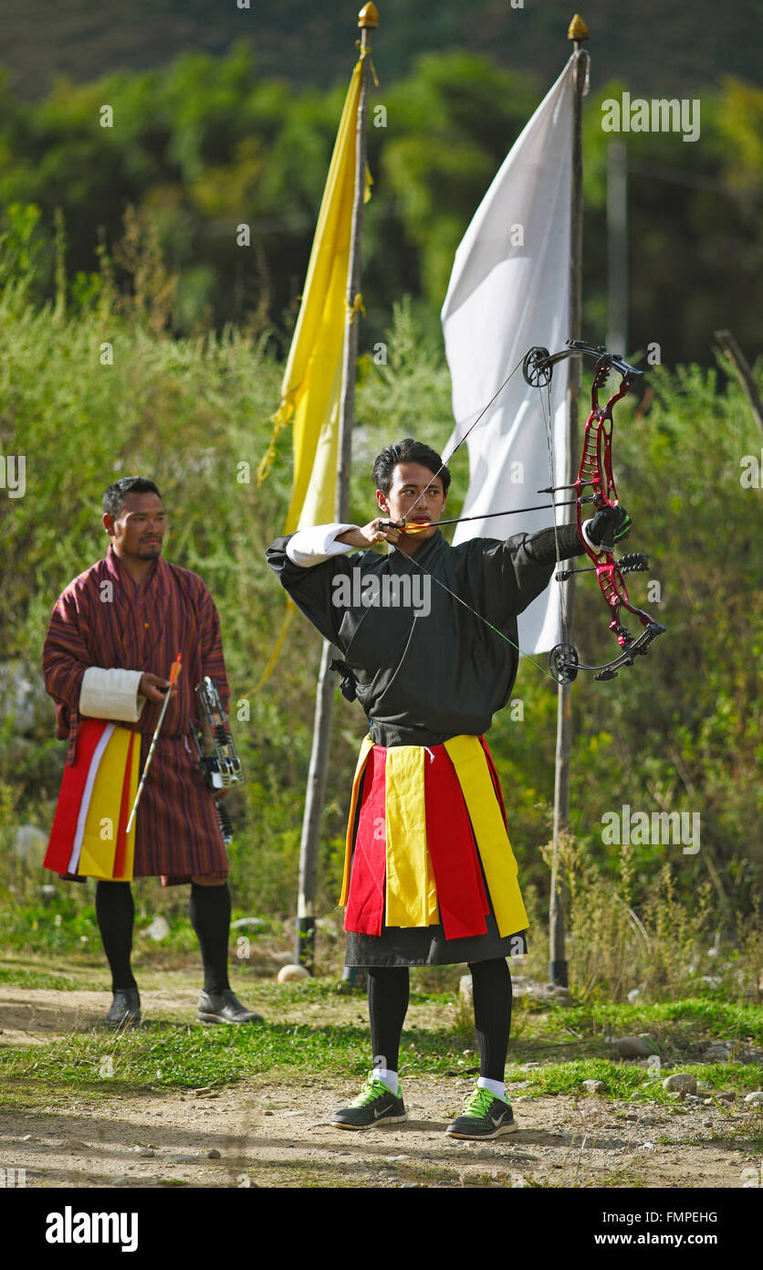 Archers with a high-tech bow wearing Gho dresses, Paro, Paro province, Kingdom of Bhutan Stock Photo