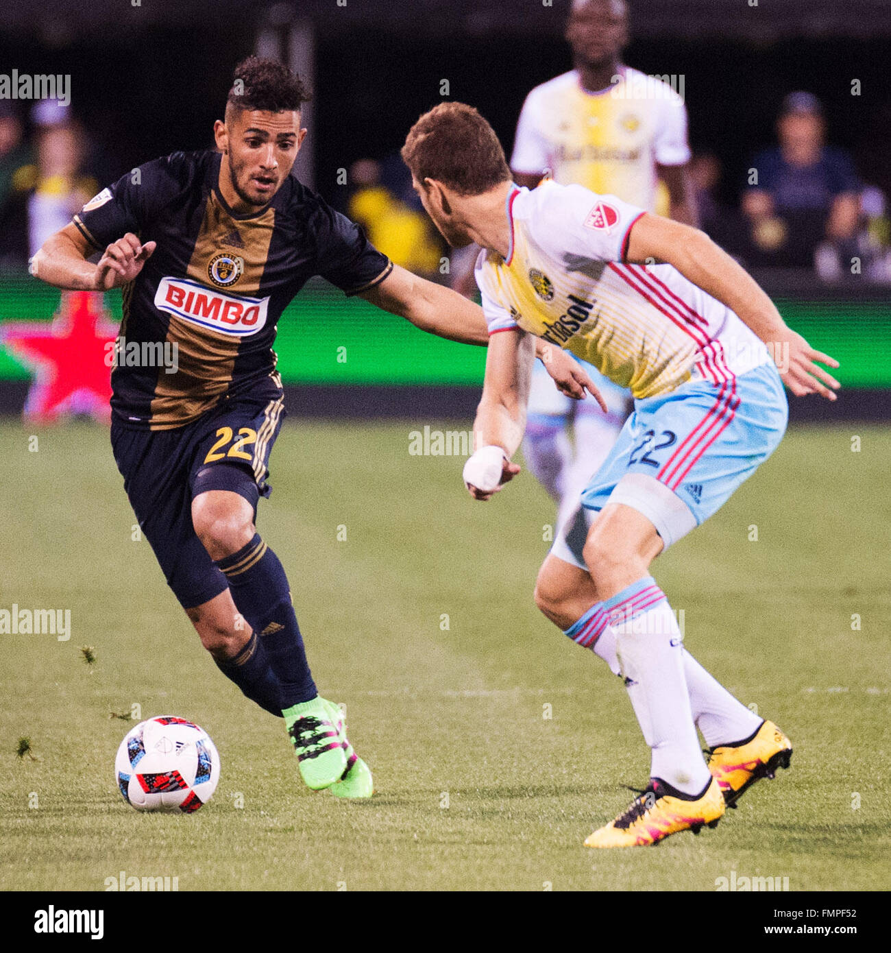 Columbus, Ohio, USA. 12th March, 2016. Philadelphia Union midfielder Leo Fernandes (22) goes one on one with Columbus Crew defender Gaston Sauro (22) in their match at Mapfre Stadium. Columbus, Ohio, USA. Columbus, Ohio, USA Credit:  Brent Clark/Alamy Live News Stock Photo