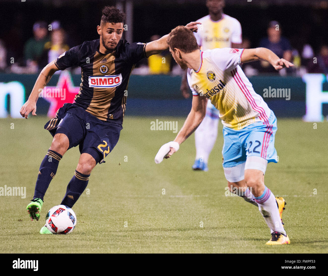 Columbus, Ohio, USA. 12th March, 2016. Philadelphia Union midfielder Leo Fernandes (22) goes one on one with Columbus Crew defender Gaston Sauro (22) in their match at Mapfre Stadium. Columbus, Ohio, USA. Columbus, Ohio, USA Credit:  Brent Clark/Alamy Live News Stock Photo