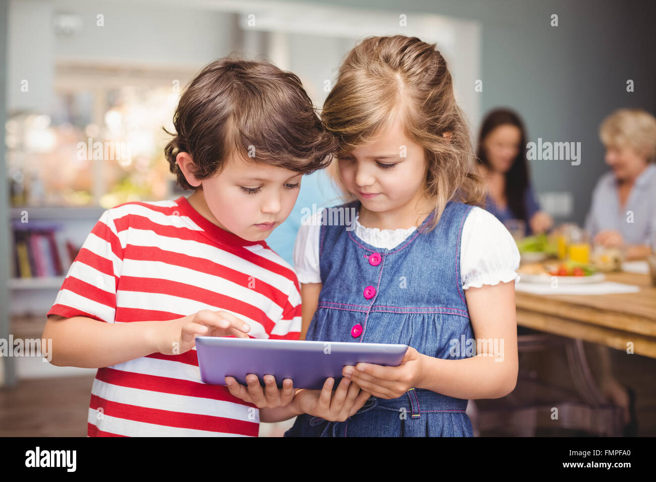 Brother and sister using digital tablet Stock Photo - Alamy