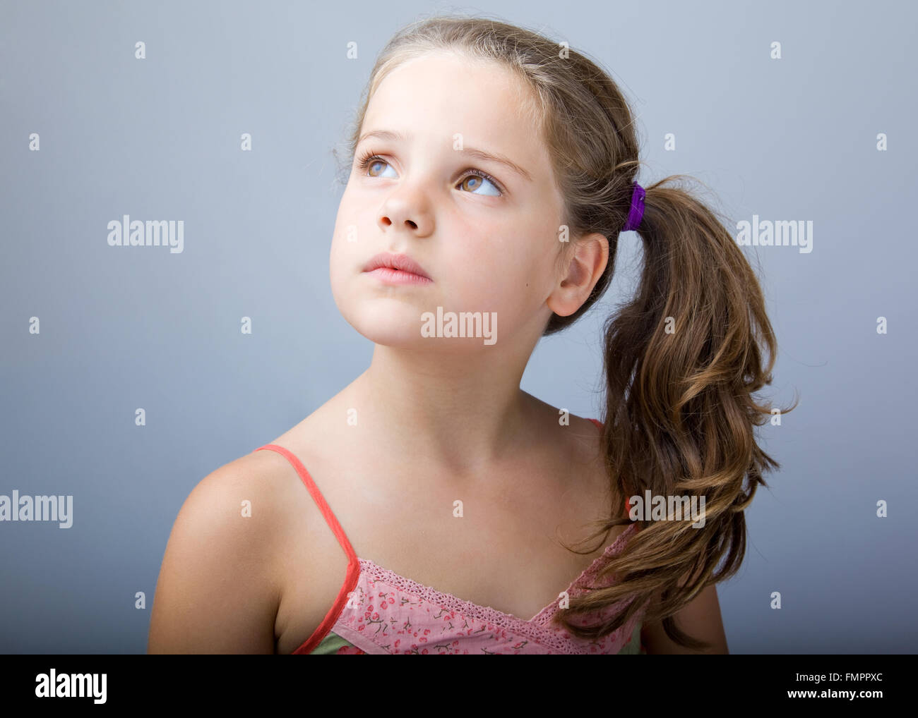 closeup image of a beautiful little girl looking up Stock Photo - Alamy