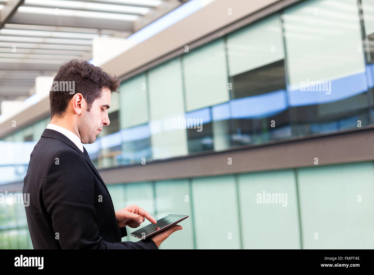 young businessman using his digital tablet at the office Stock Photo ...