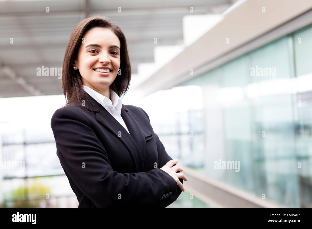 Portrait of a well-dressed young business woman with cross-armed Stock Photo