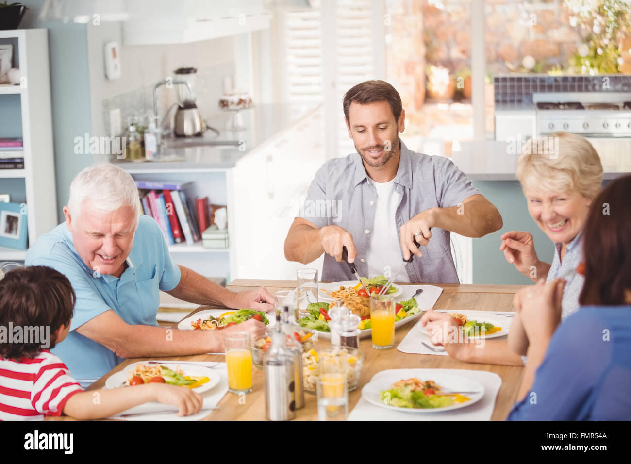 Happy family family having breakfast at home Stock Photo - Alamy