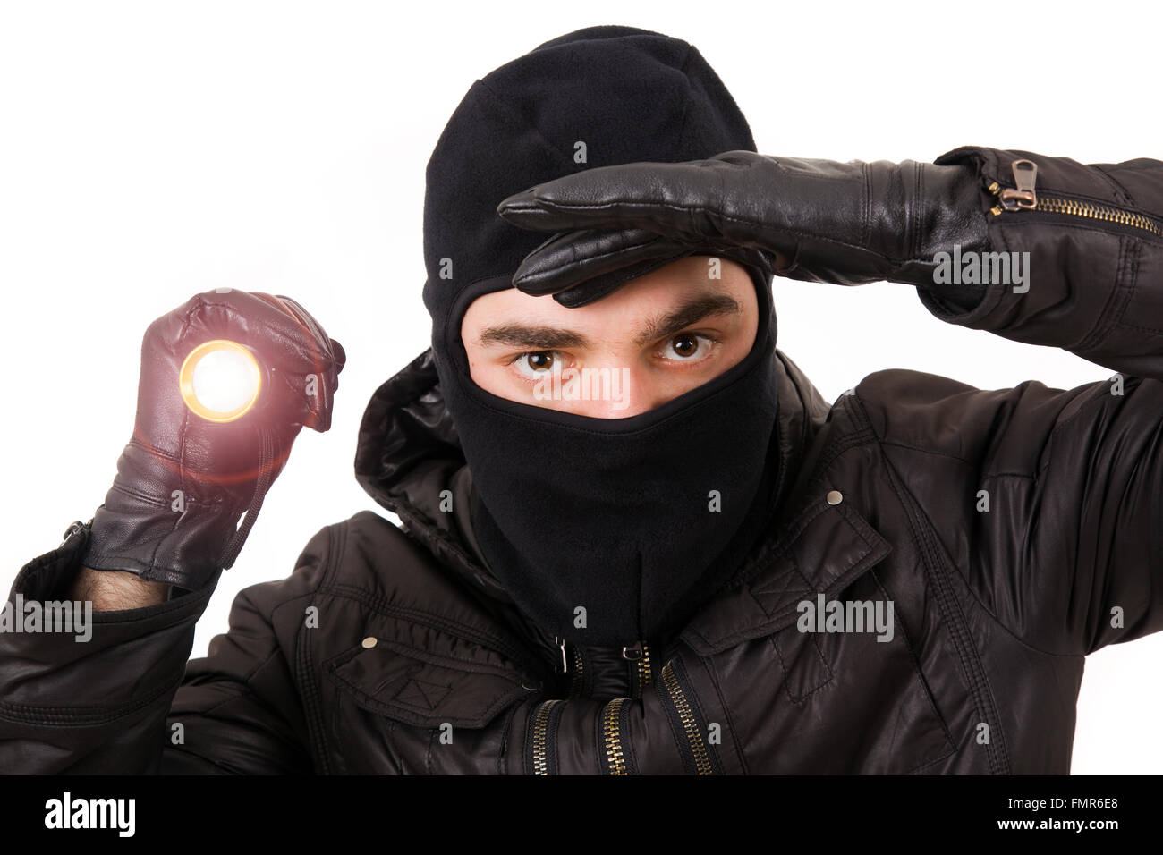 Thief with flashlight isolated in white background Stock Photo - Alamy