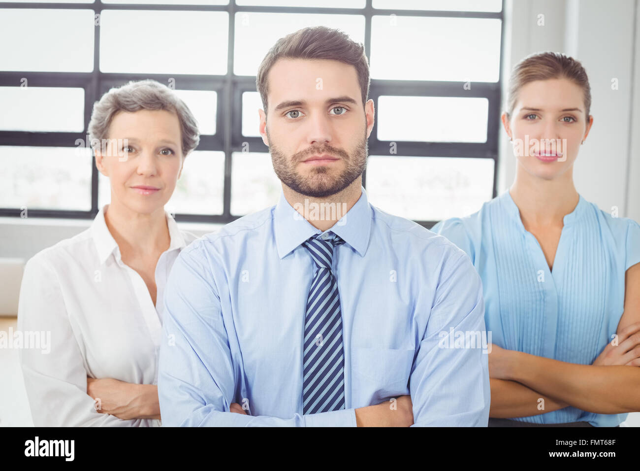 Confident business people with arms crossed in office Stock Photo - Alamy