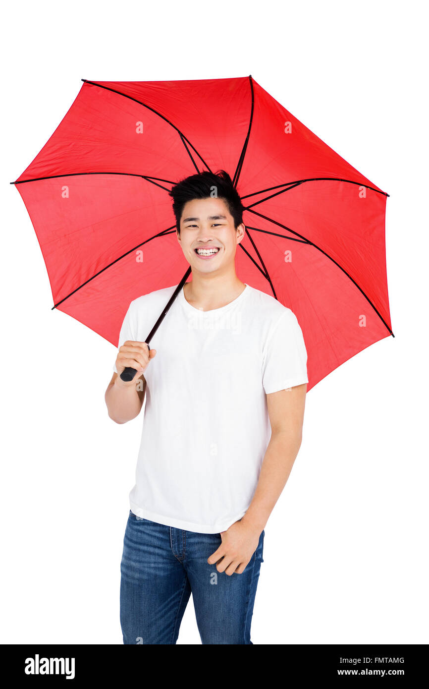 Young man holding a umbrella Stock Photo - Alamy