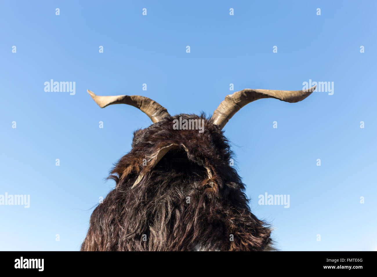 Mask with horns on a blue sky background Stock Photo - Alamy
