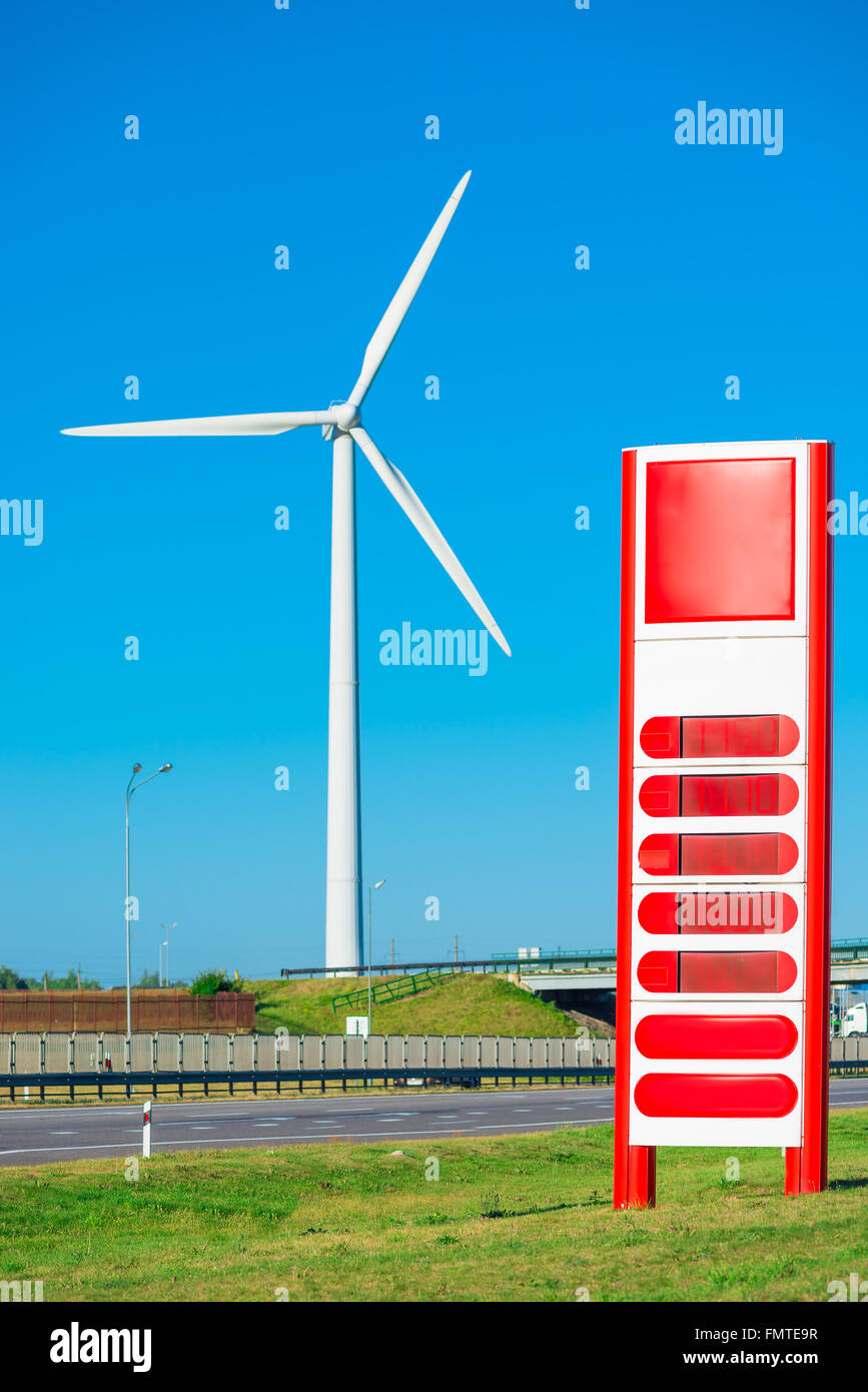 Windmill in the field and a petrol station near the road Stock Photo ...