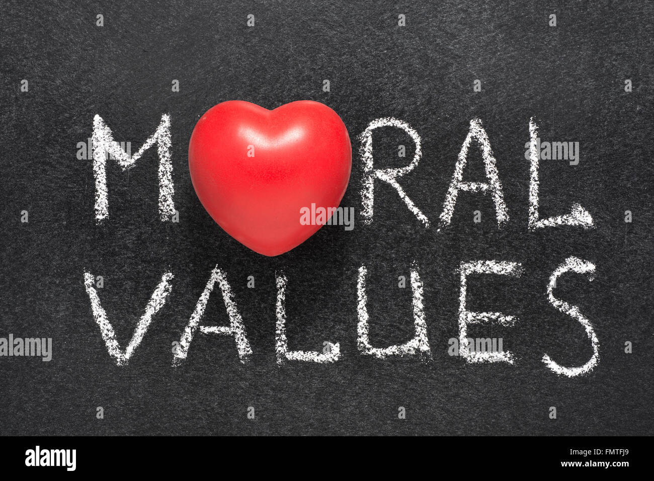 moral values phrase handwritten on blackboard with heart symbol instead O Stock Photo