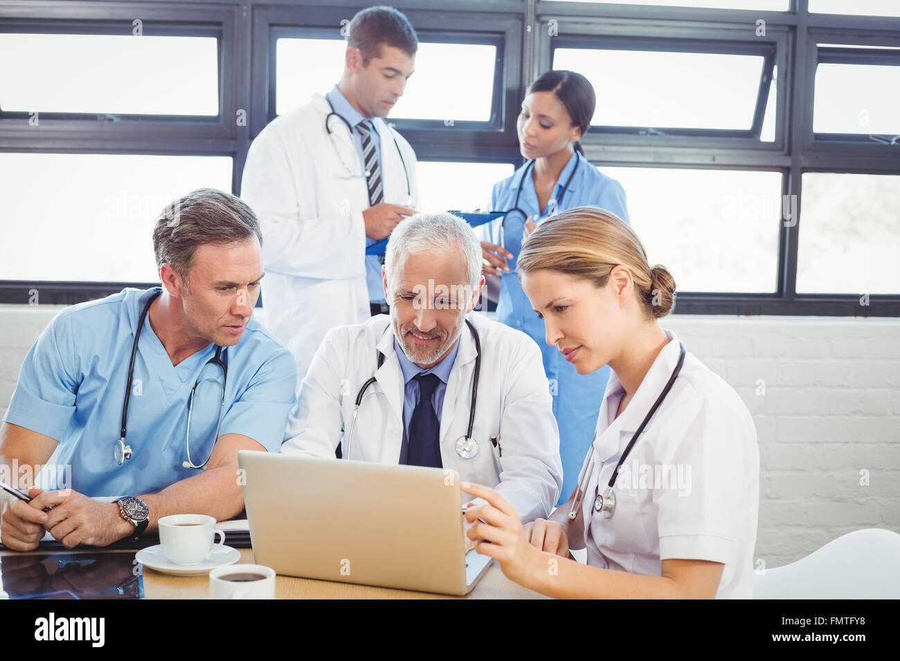 Medical team using laptop in conference room Stock Photo - Alamy