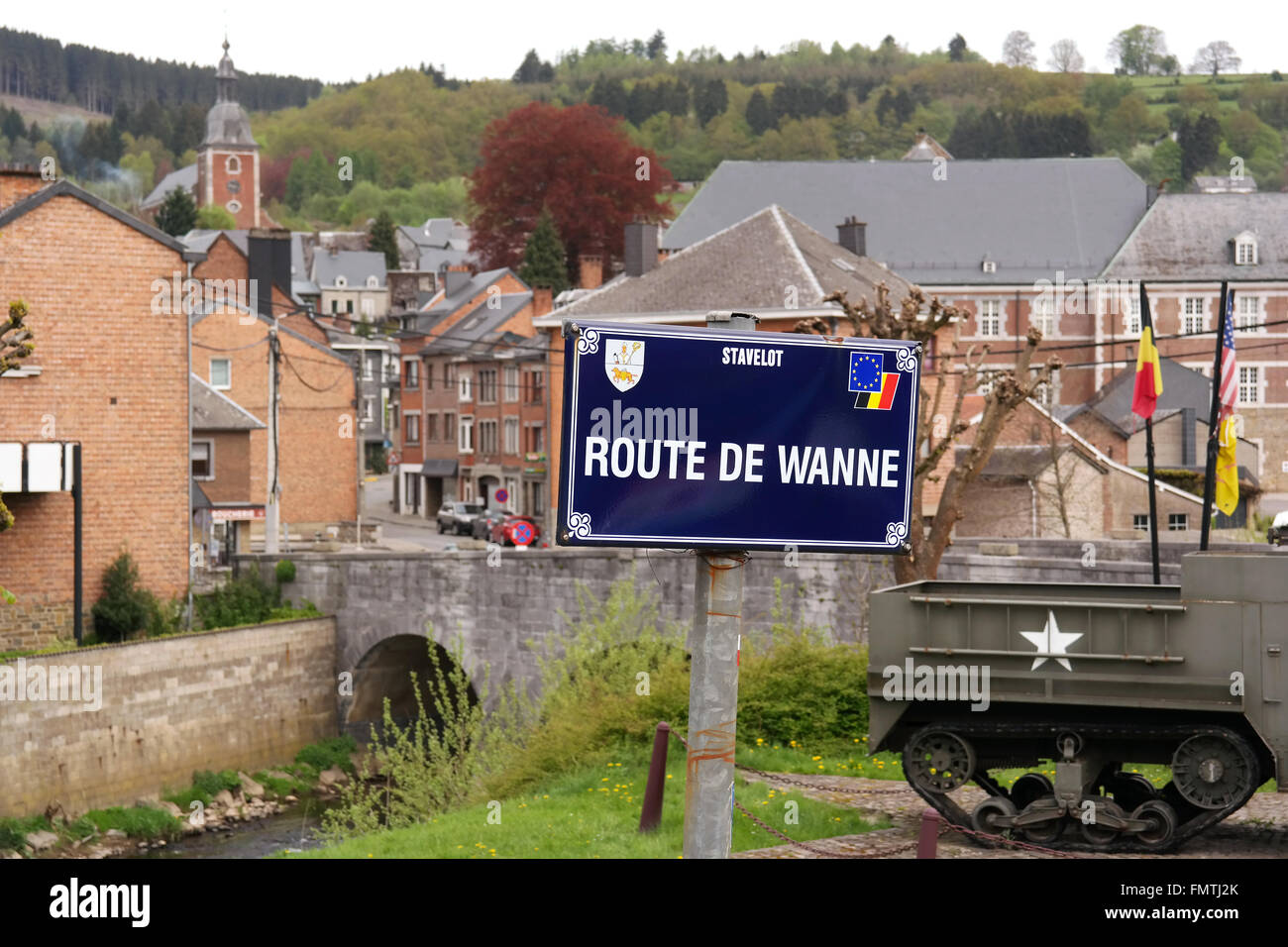 Sign Route de Wanne in front of a Halftrack, a WW2 Memorial of the 30th Infantry Division - near the bridge of Stavelot, Belgium Stock Photo