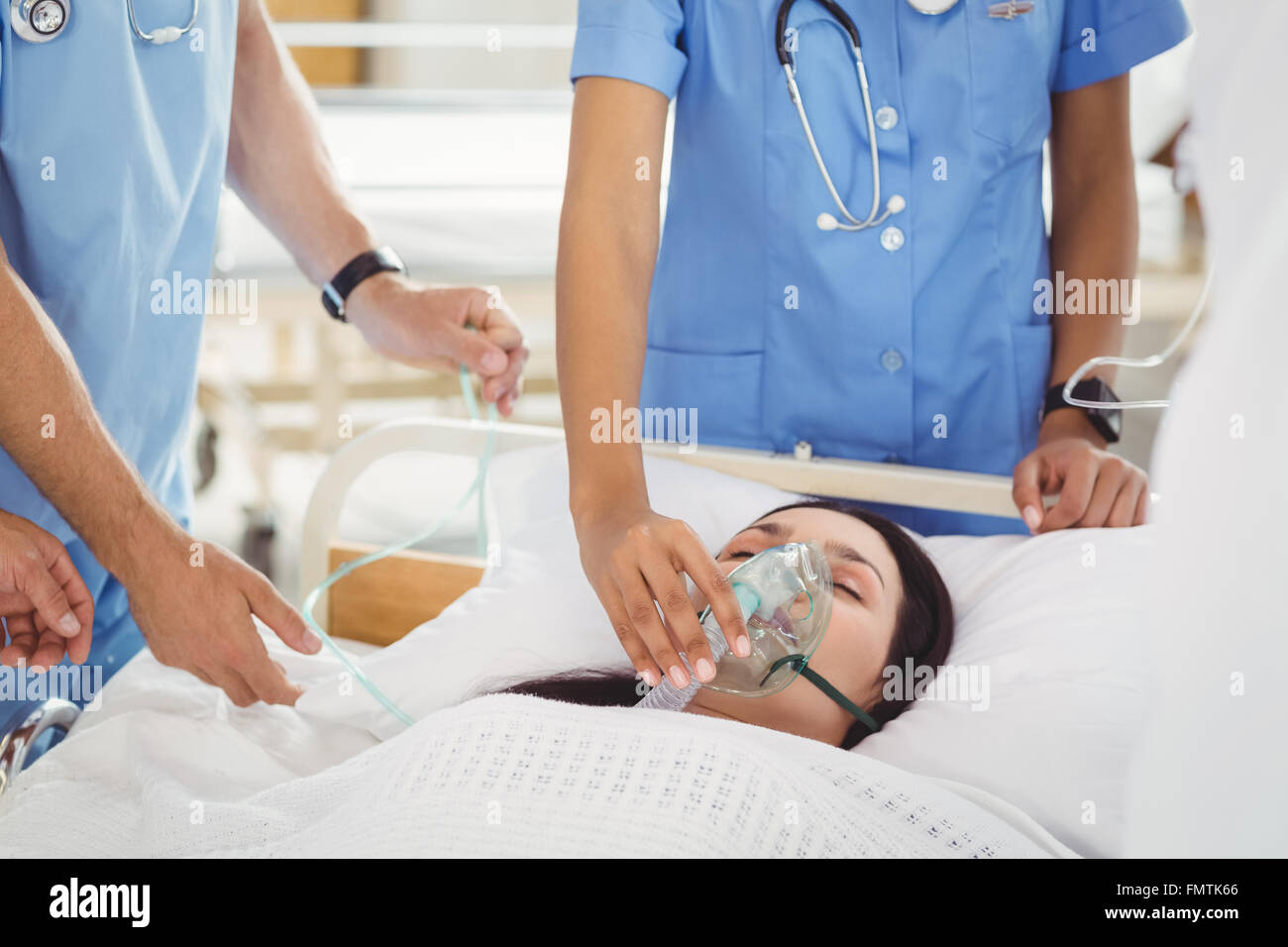 Doctors putting an oxygen mask on patient Stock Photo Alamy