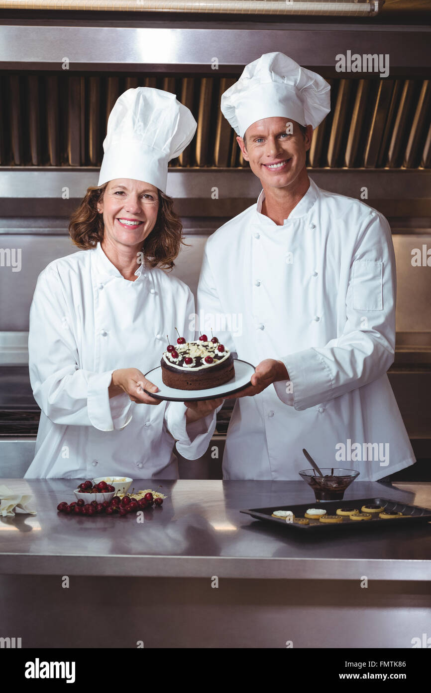 Chefs presenting the cake they just made Stock Photo Alamy