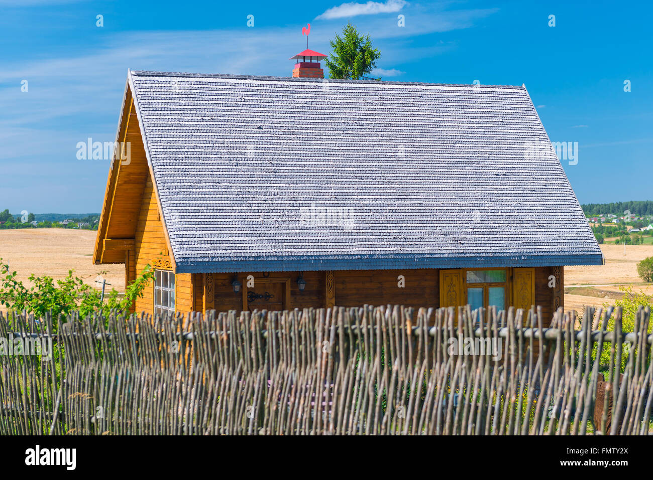 wooden house with a fence in the village Stock Photo