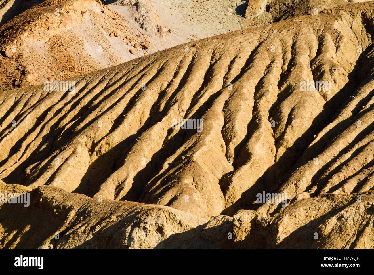 Geologic forms in late afternoon sun along Badwater Road, Death Valley, CA Stock Photo