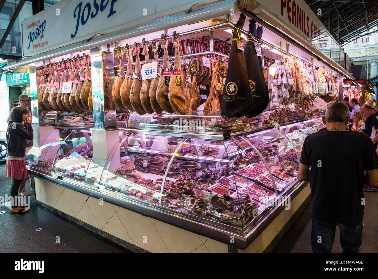 Meat shop with Jamon iberico drycured ham at Mercat de Sant Josep de