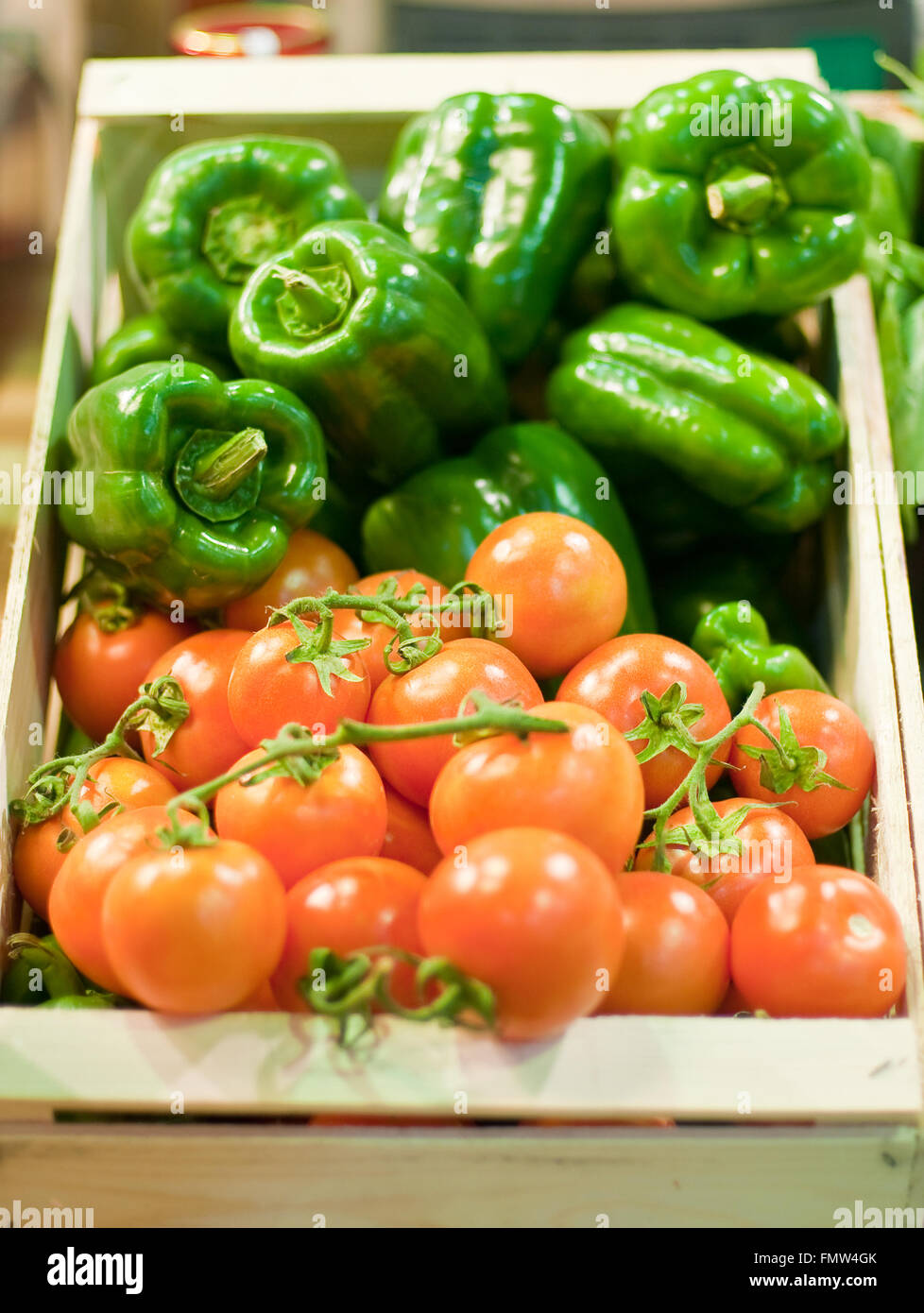 wooden box containing tomatoes and green peppers,fruit Stock Photo