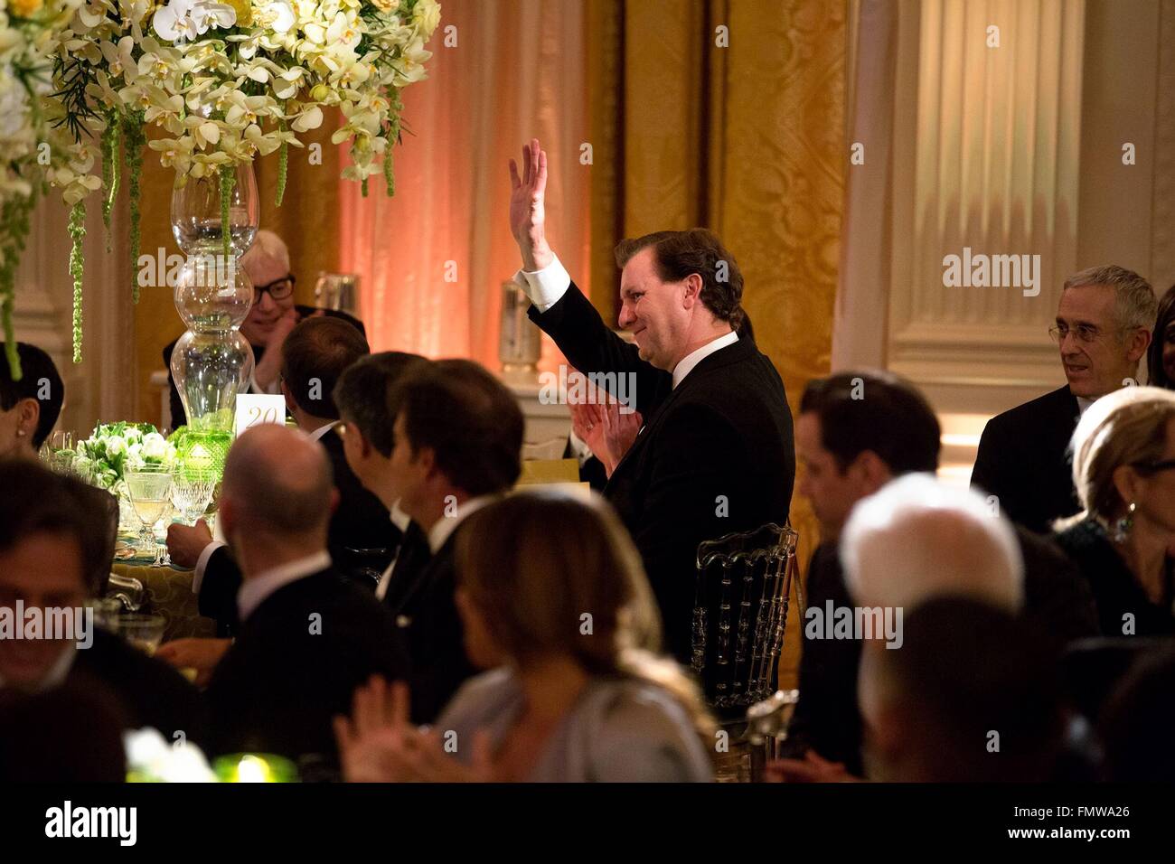 Marvin Nicholson, the personal aide to U.S. President Barack Obama waves after being acknowledged during the President's remarks at the State Dinner for Canadian Prime Minister Justin Trudeau in the East Room of the White House March 10, 2016 in Washington, DC. This is the first state visit by a Canadian Prime Minister in 20-years. Stock Photo