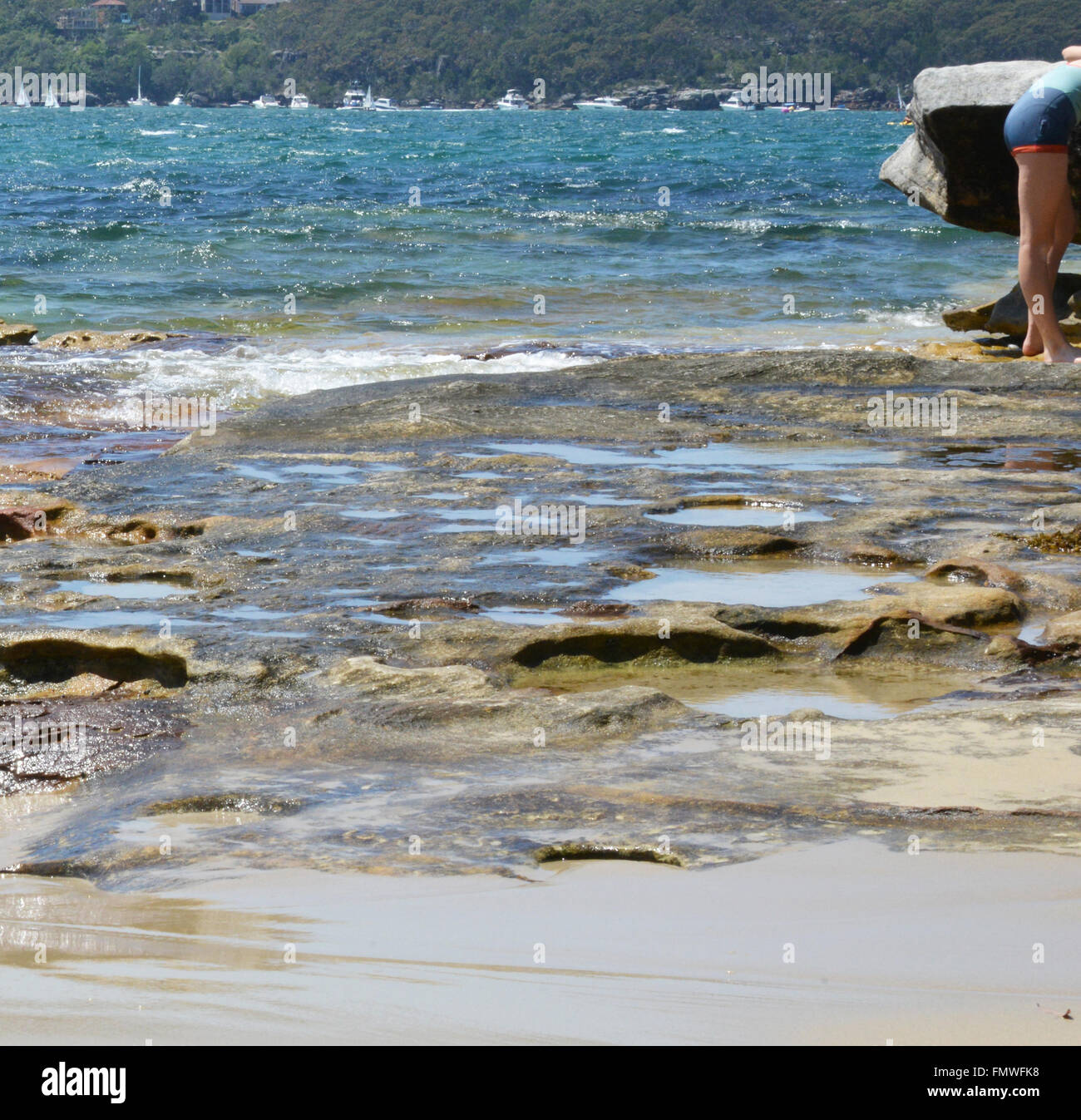 Beach scene, girl on rocks, Sydney Australia Stock Photo