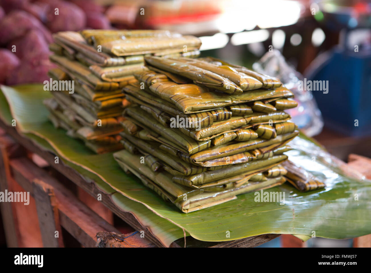 Suman,a traditional dessert of the Philippines,made with glutionous rice which is wrapped in palm leaves and then steamed. Stock Photo