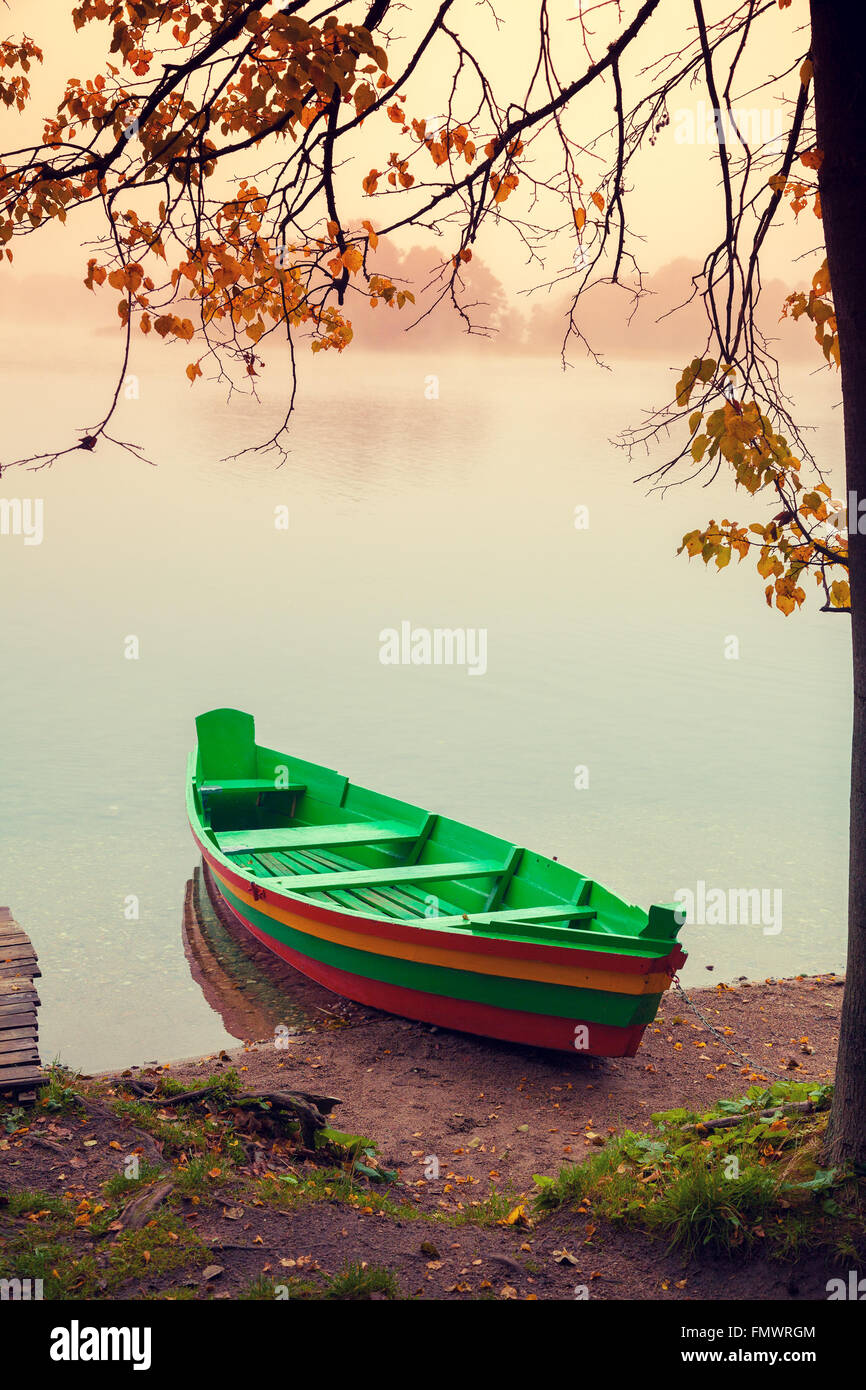 Autumn misty morning. Wooden boat on the river bank Stock Photo - Alamy