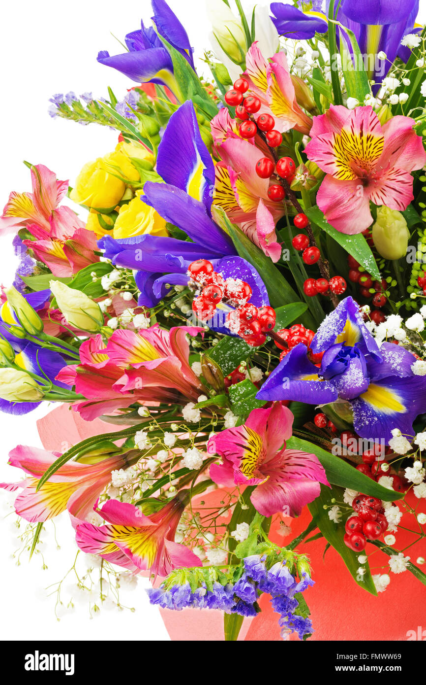 Fragment of delicate beautiful bouquet from nerine, iris, alstroemeria, roses and other flowers in red packaging isolated on whi Stock Photo