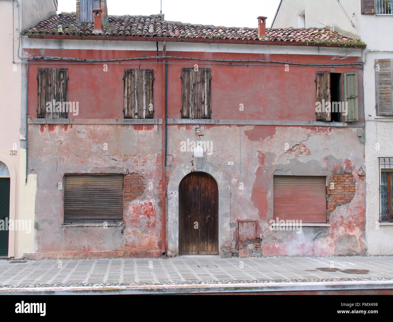 A red house with wooden door and windows Stock Photo - Alamy