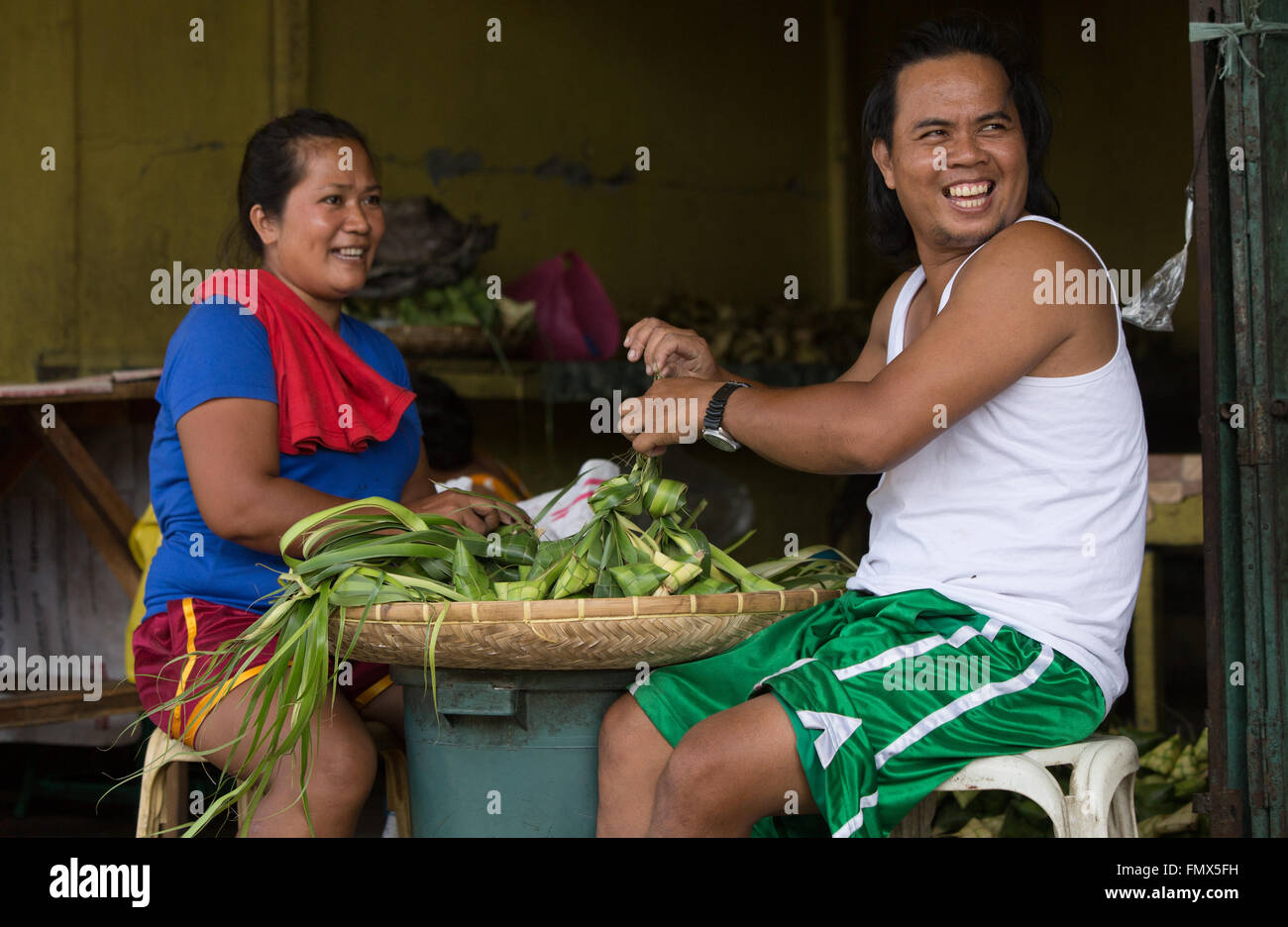Hanging Rice being made which is then steamed in young woven coconut leaves,known as Puso,in the Visayas area of the Philippines Stock Photo