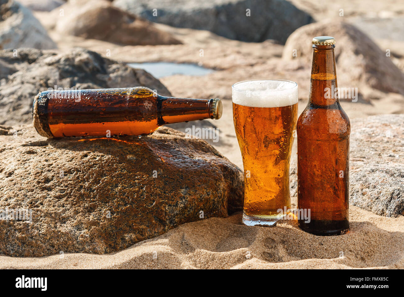 Object photo. Cold beer in brown bottle with drinking glass on the beautiful sandy beach. Concepts of vacation and summer holidays Stock Photo - Alamy Object photo. Cold beer in brown bottle with drinking glass on the beautiful sandy beach. Concepts of vacation and summer holidays Stock Photo - Alamy