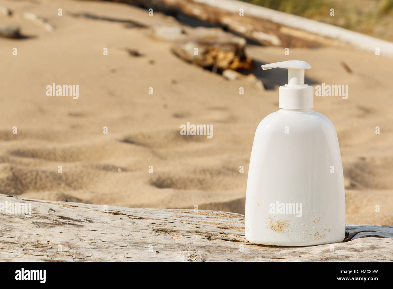 White bottle of cosmetics on the beach Stock Photo