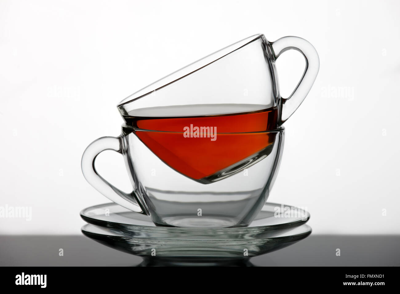 Two tea cups with black tea, photographed on a gleam Stock Photo Alamy
