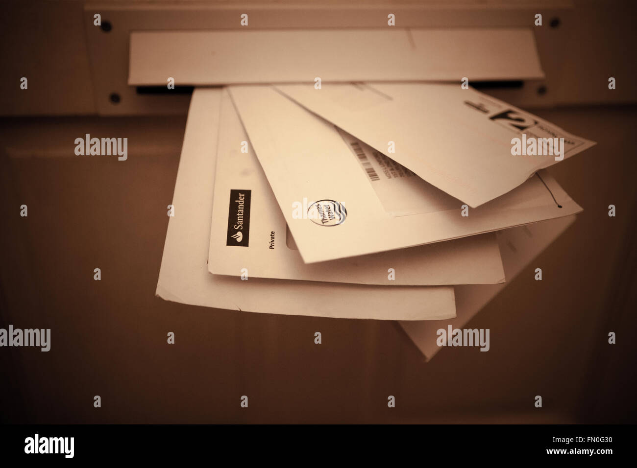 Bills and statements in a letterbox Stock Photo Alamy