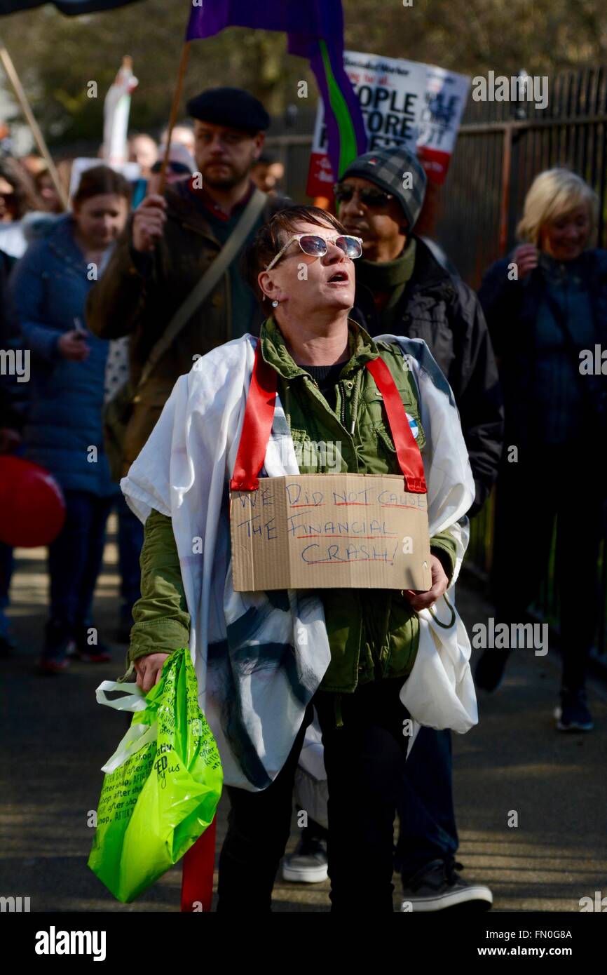 London, UK. 13th March 2016. Protester holds a message written on cardboard to protest the new Housing Bill. Credit:  Marc Ward/Alamy Live News Stock Photo