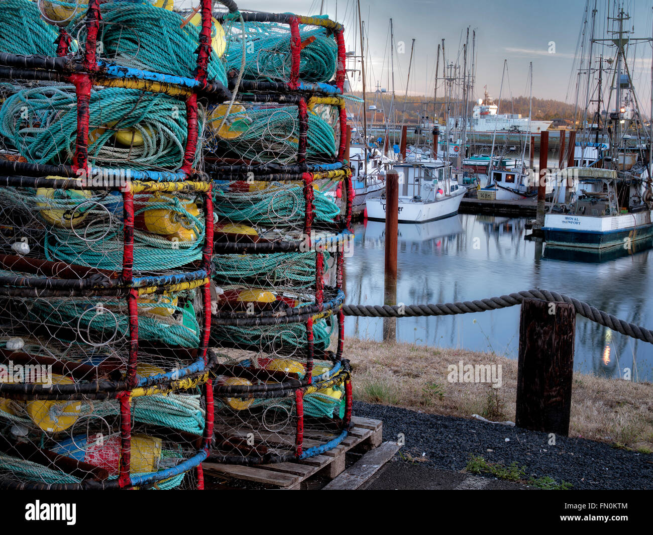 Crab pots and boats at Newport Harbor on the Yaquina River, Oregon Stock Photo