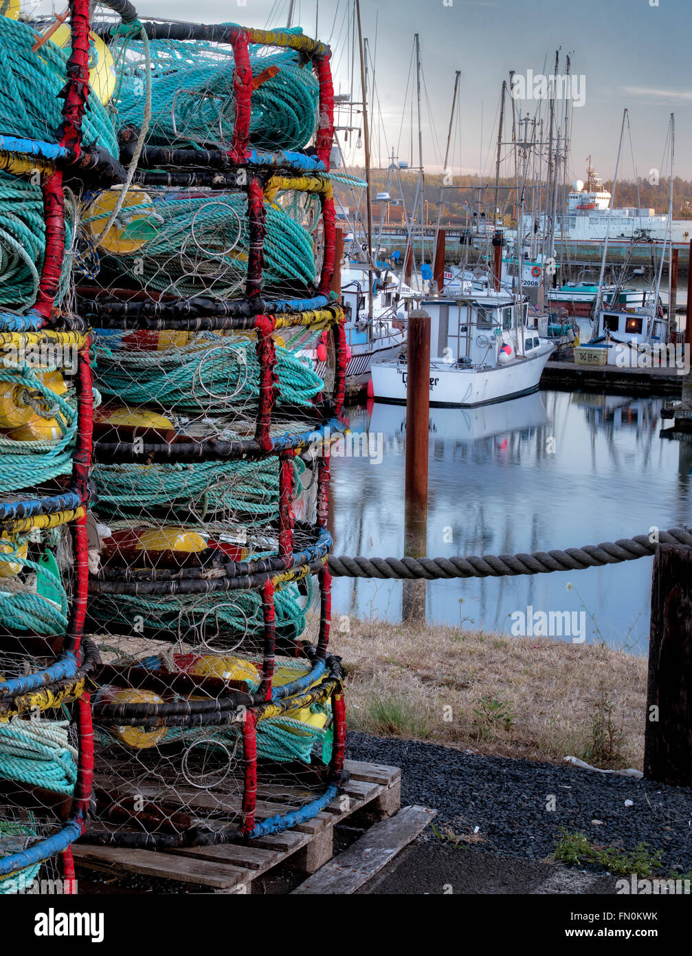 Crab pots and boats at Newport Harbor on the Yaquina River, Oregon Stock Photo