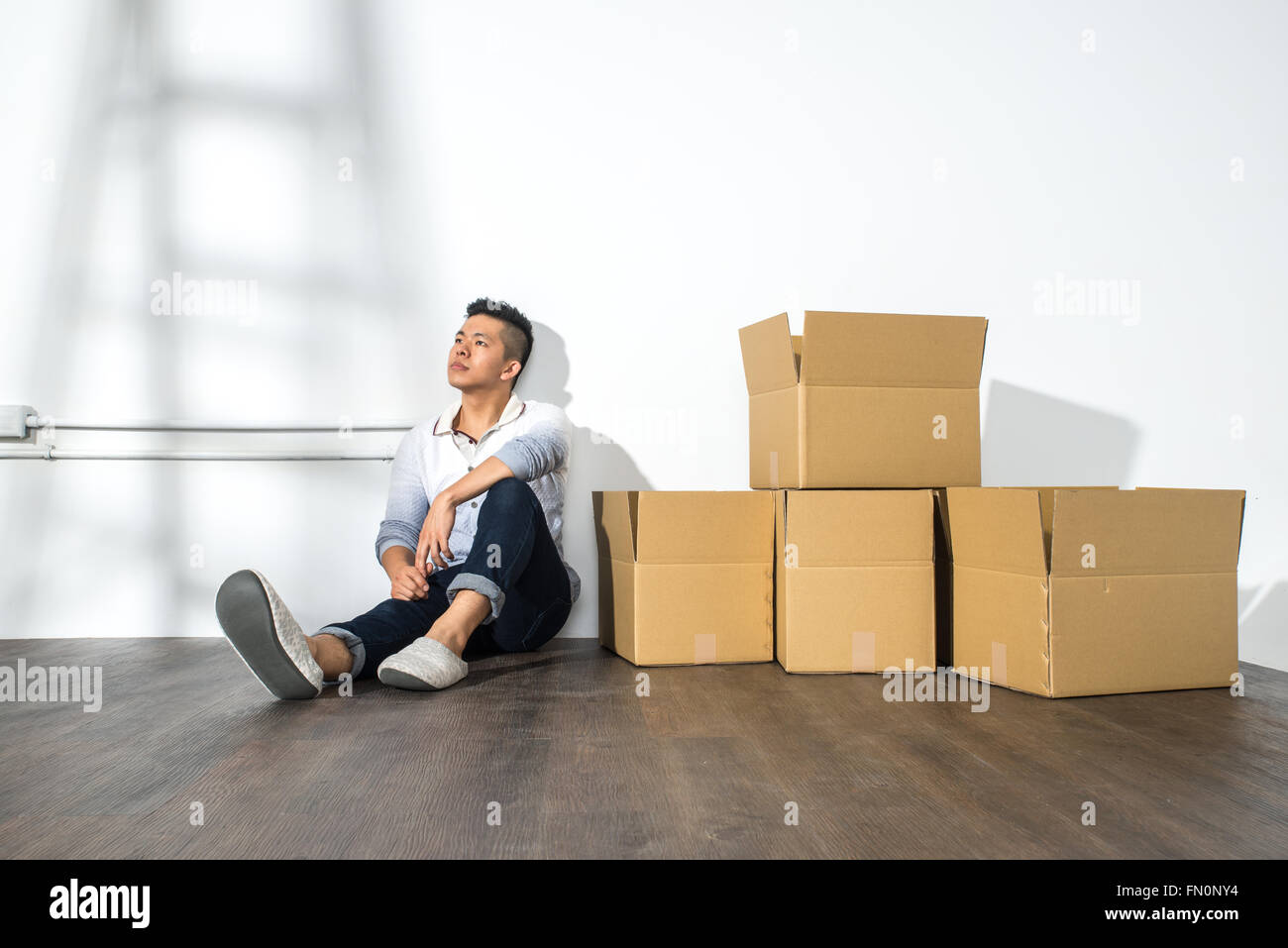 Sitting man sitting on boxes hi-res stock photography and images - Alamy