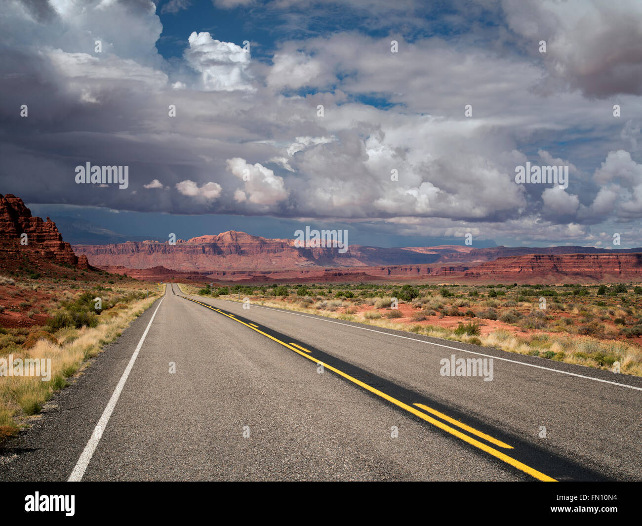 Road and mountains with storm clouds. Scenic Byway Hwy 95, Glen Canyon National Recreation Area, Utah Stock Photo