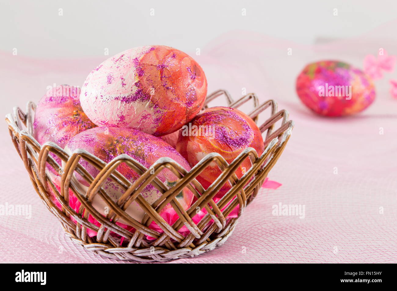 Pink decoupage decorated Easter eggs in a wicker basket Stock Photo - Alamy