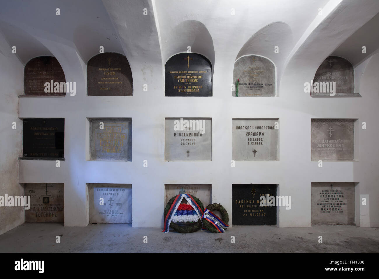 Graves of the most notable persons of the Russian emigration in Czechoslovakia in the underground crypt of the Dormition Church at the Olsany Cemetery in Prague, Czech Republic. Graves of the first Prime Minister of Czechoslovakia Karel Kramar and his Russian wife Nadezhda Kramar, nee Khludova, are seen in the centre. Graves in the upper line from left to right: Olga Ryzhkova and Ariadna Ryzhkova, a widow and a daughter of Russian priest Nikolai Ryzhkov, Russian general Timofey Semernikov and his wife Yevgenia Semernikova, Ukrainian politician Semyon Bulyk and his wife Alexandra Bulyk, Russian Stock Photo