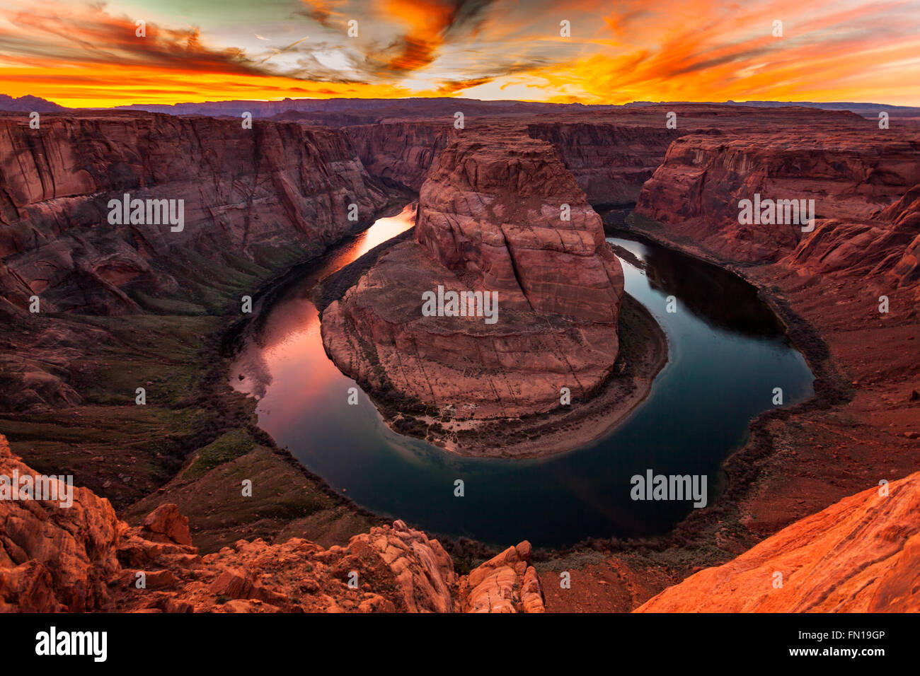 The Colorado River wraps around Horseshoe Bend at sunset in Page, Arizona Stock Photo