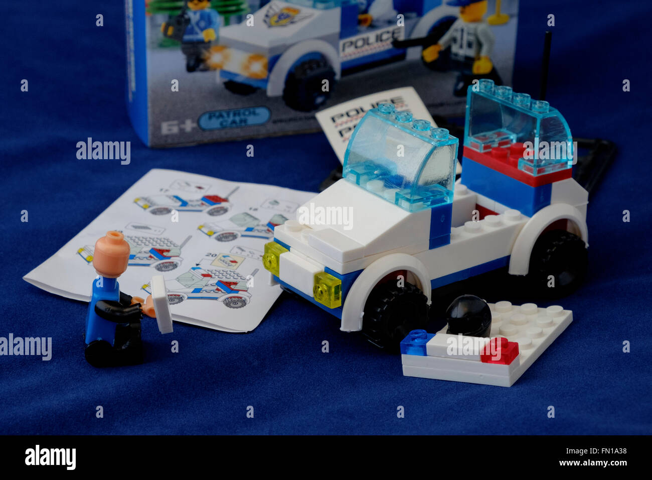 Model Assembly of a toy Police Car using building blocks Stock Photo